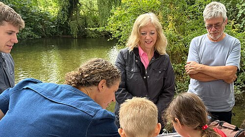 Liz Jarvis MP testing river water with volunteers