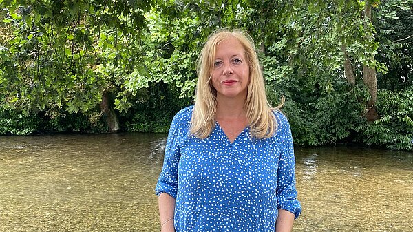 Liz J stood in river